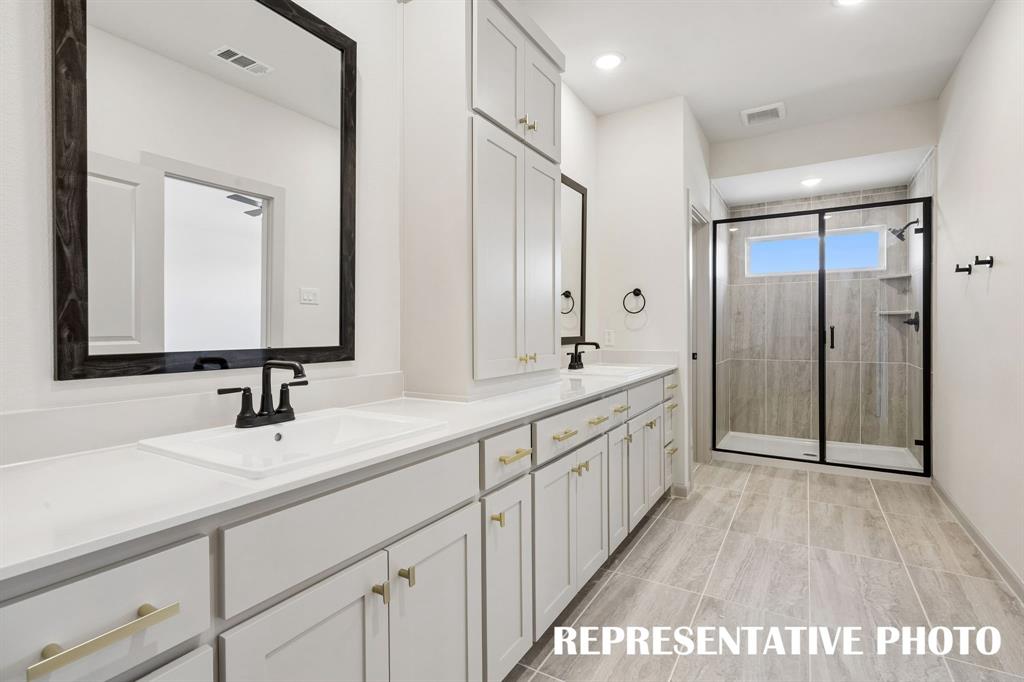 With room to spread out and a spacious walk in shower, this owner's bath is the prefect place to start or end your day!  REPRESENTATIVE PHOTO