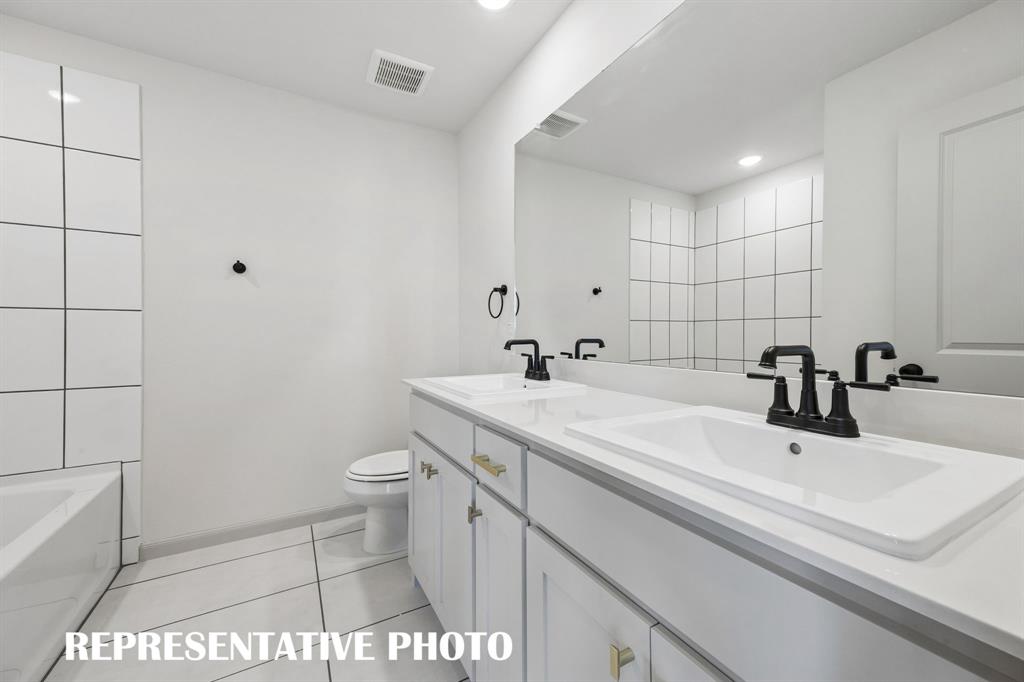 Guests will enjoy their own vanity space in this thoughtfully designed guest bath.  REPRESENTATIVE PHOTO