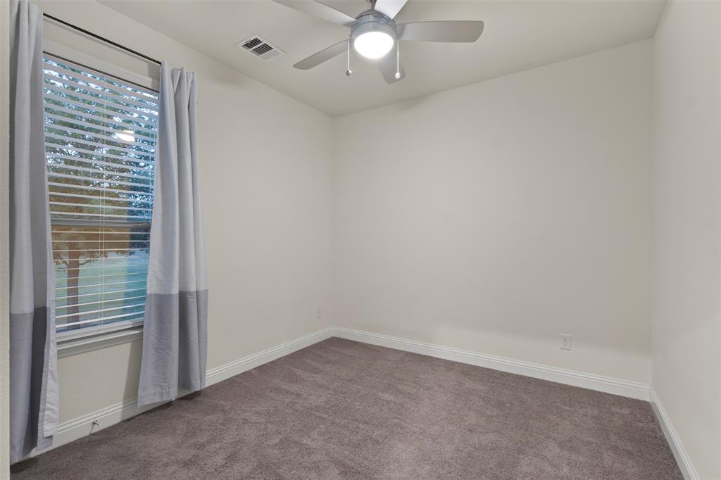 Window with blinds, wall-to-wall carpeting, ceiling fan with integrated lighting, and white baseboards