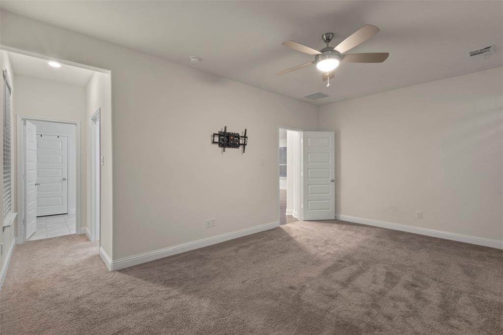 Plush carpeting, recessed lighting, and a ceiling fan with integrated light