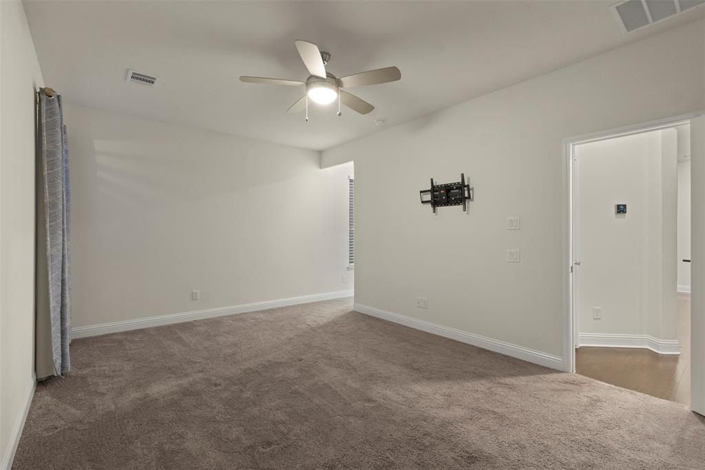 Neutral wall tones, recessed lighting, and a ceiling fan with integrated lighting