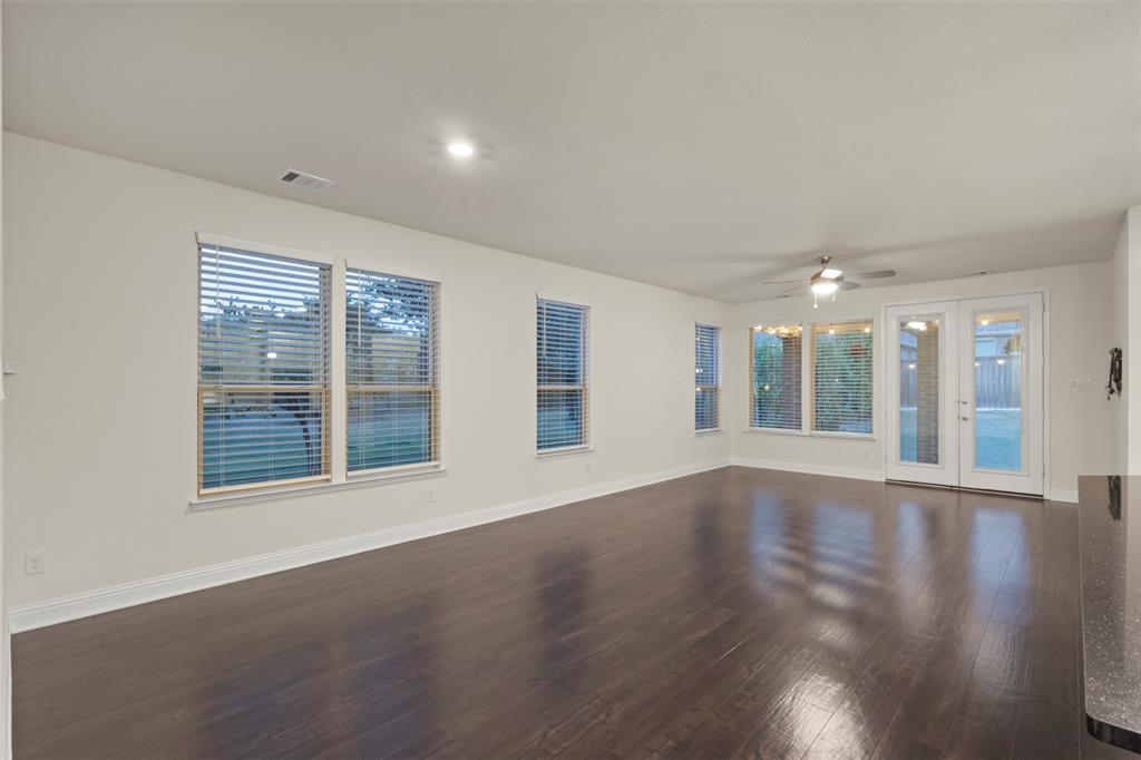 Dark wood-finish flooring, recessed lighting, and white walls