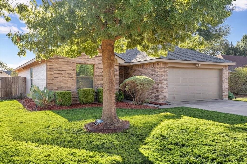 Brick exterior with a gabled roof and attached garage