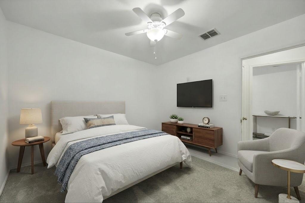 Carpet flooring, white walls, and a ceiling fan with integrated lighting