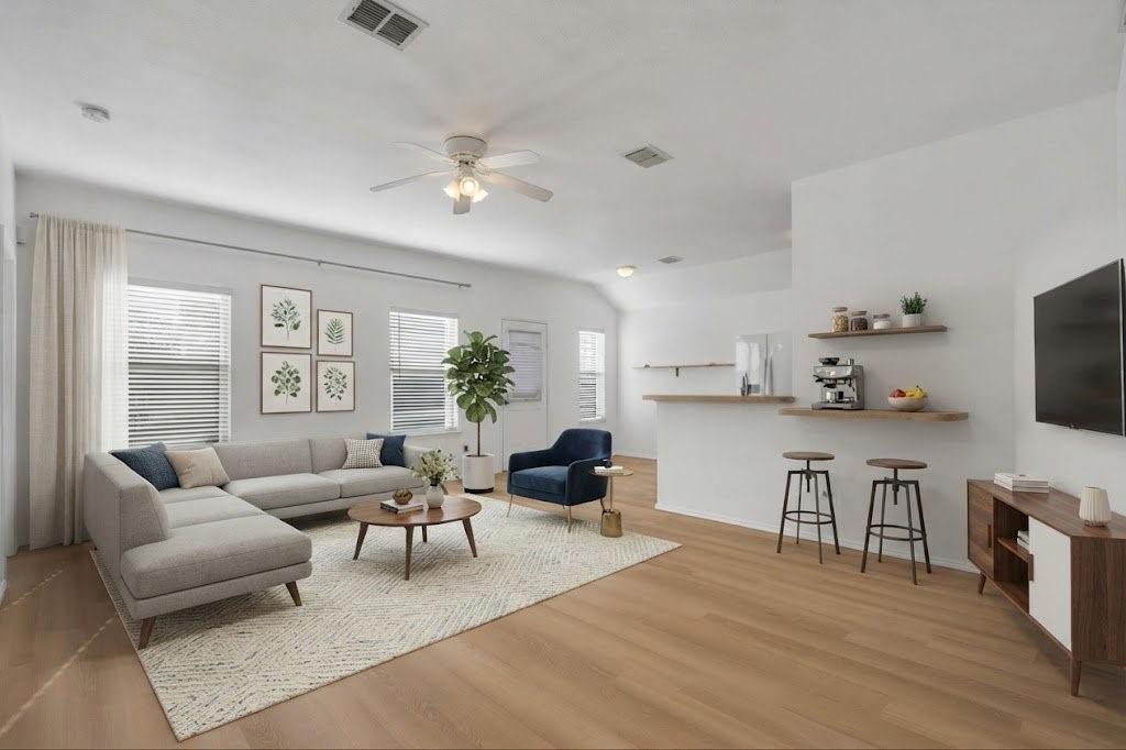 Wood-finish flooring, white walls, and a ceiling fan