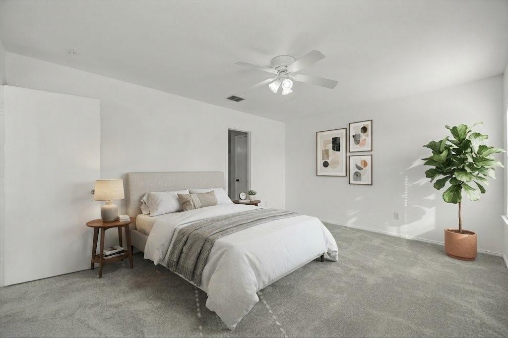 Plush carpet flooring, ceiling fan with integrated lighting, window with natural light, white wall finishes