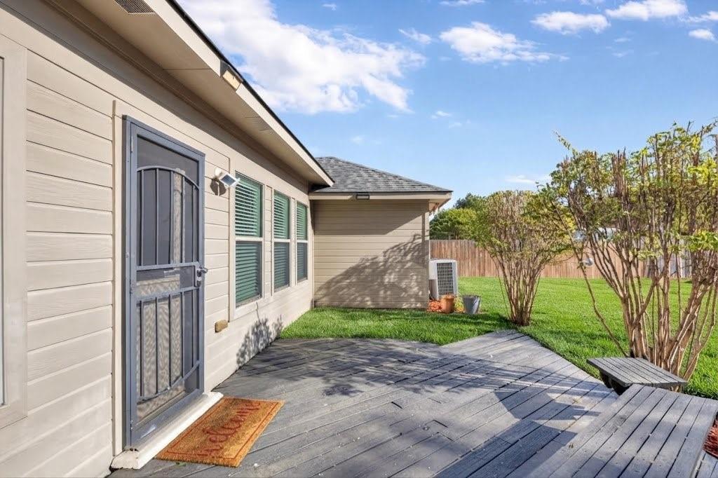 Exterior siding with multiple windows and a security screen door