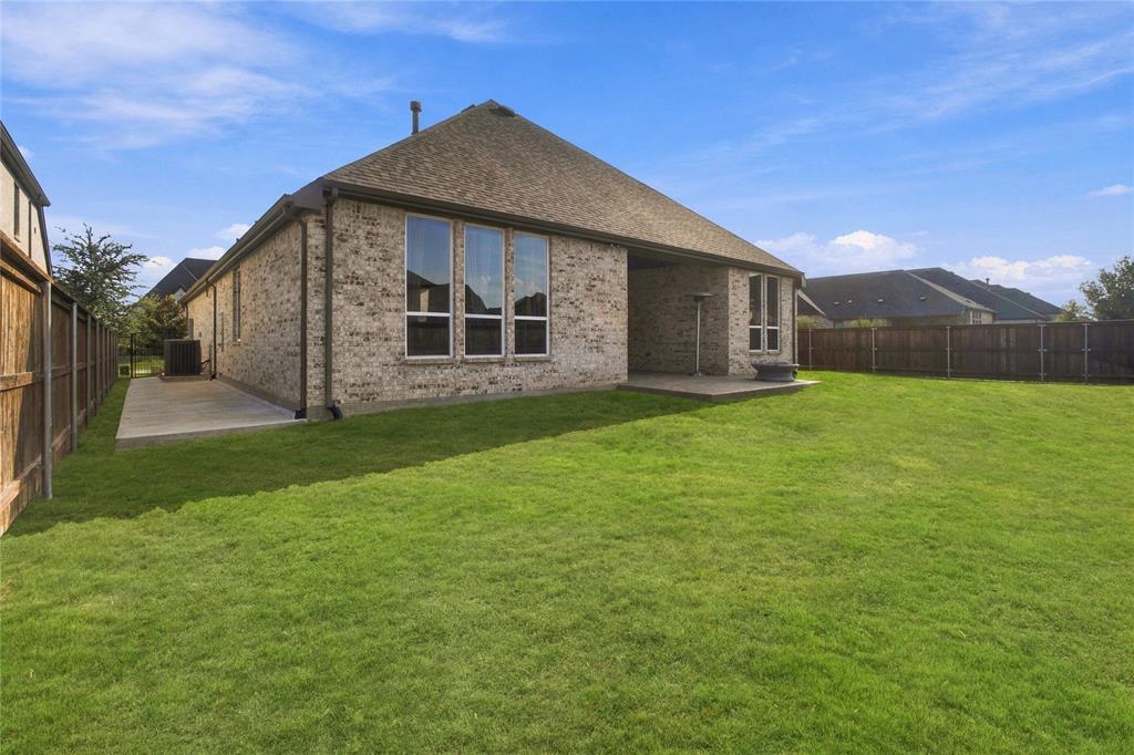 brick exterior, multiple large windows, large covered patio, Stamped concrete and privacy fencing
