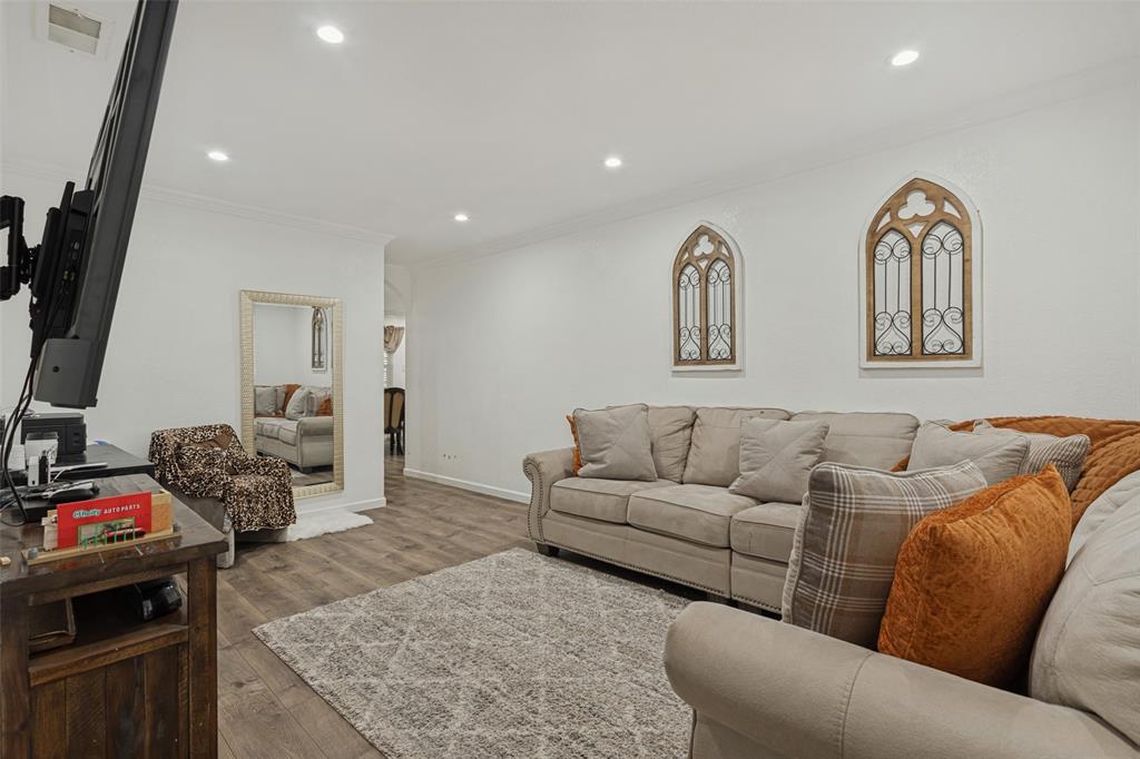 Wood-finish flooring, recessed lighting, and arched wall accents
