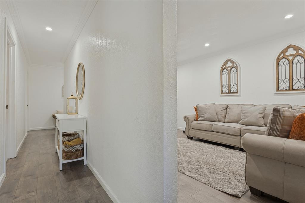 Neutral interior space featuring wood-finish flooring, recessed lighting, and crown molding