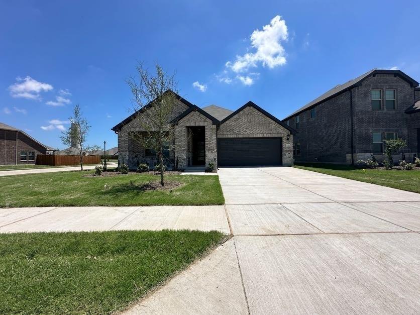 Single-story residence featuring a brick and stone facade, a two-car garage, and a concrete driveway