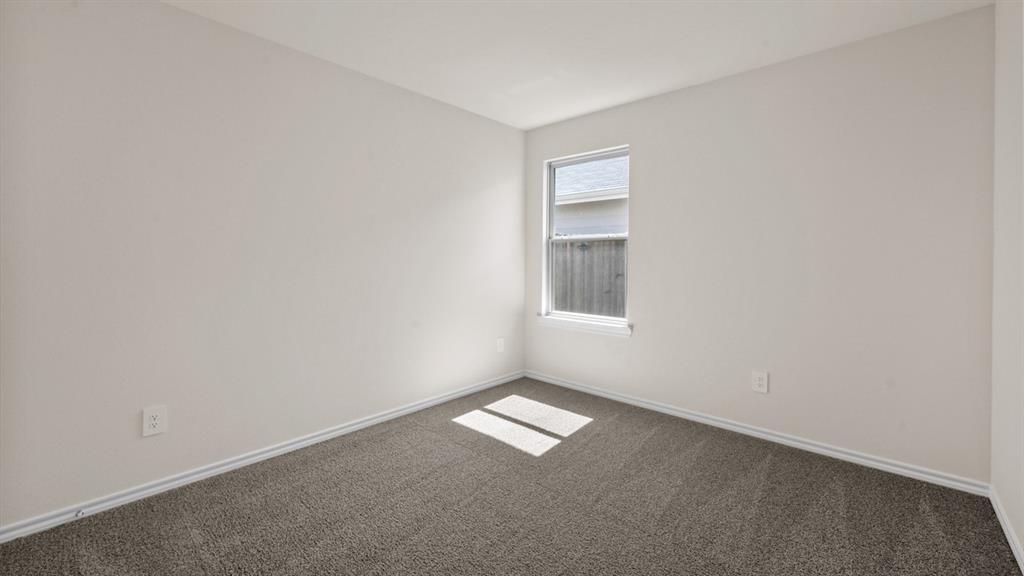 Neutral-toned walls, single-pane window, and carpeted flooring