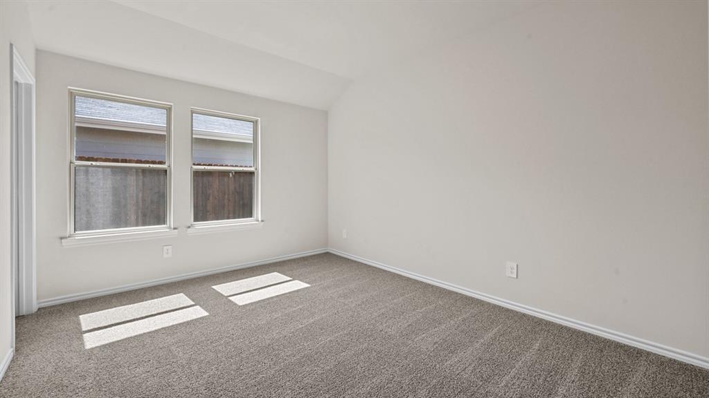 Vaulted ceiling, two pane windows, neutral wall color, gray carpet, white trim