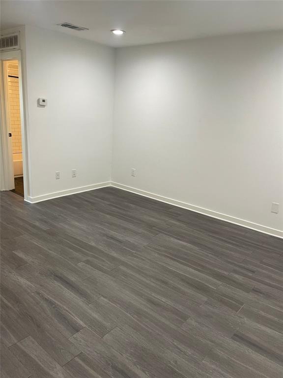 Wood-finish flooring, recessed lighting, and crisp white walls