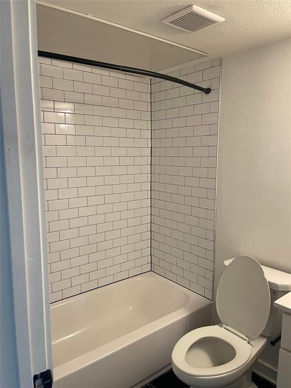 Tub/shower combination featuring white subway tile surround and a curved shower rod
