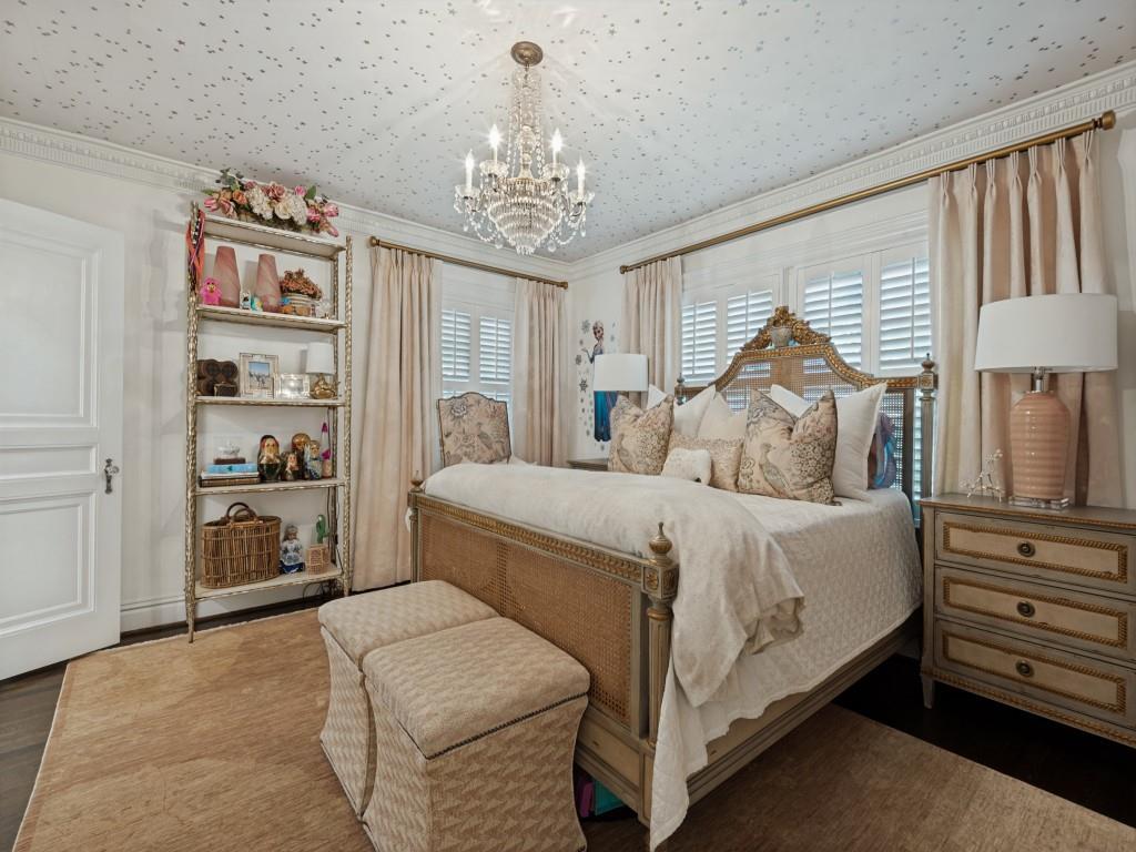Detailed crown molding, ceiling with star-patterned detailing, crystal chandelier, plantation shutters, and solid-core panel door