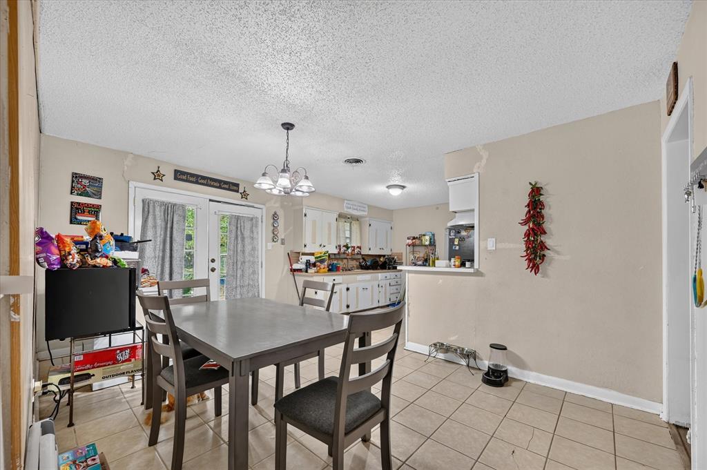 Tiled flooring, white french doors, and a kitchen pass-through window