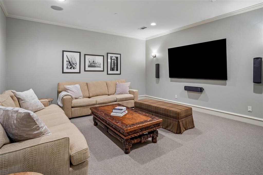 85" wall-mounted TV display, wall-mounted speakers.