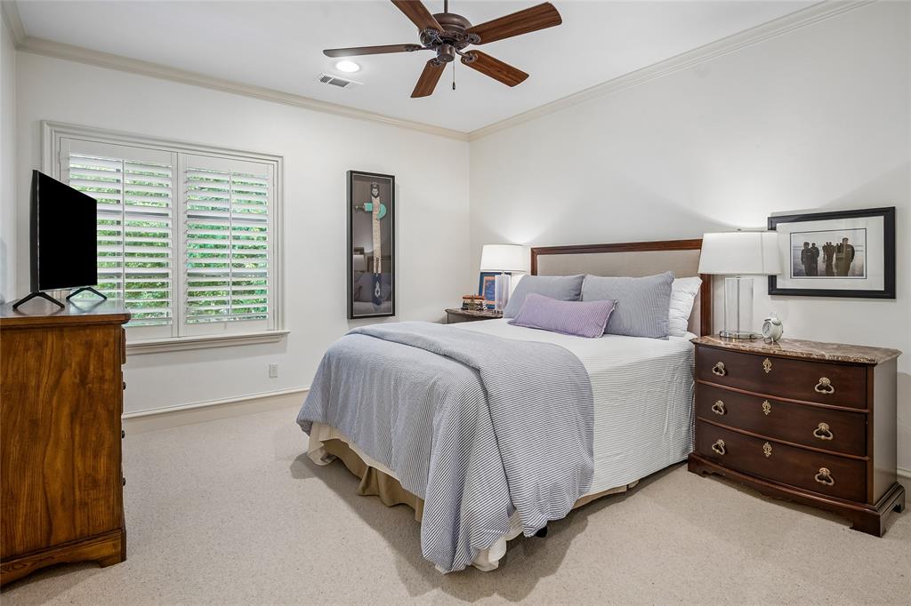 Bedroom suite #3 Window with plantation shutters, ceiling fan, crown molding, and neutral-toned wall paint