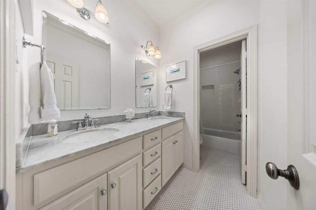 Dual vanity with undermount sinks, gray countertop, and chrome fixtures