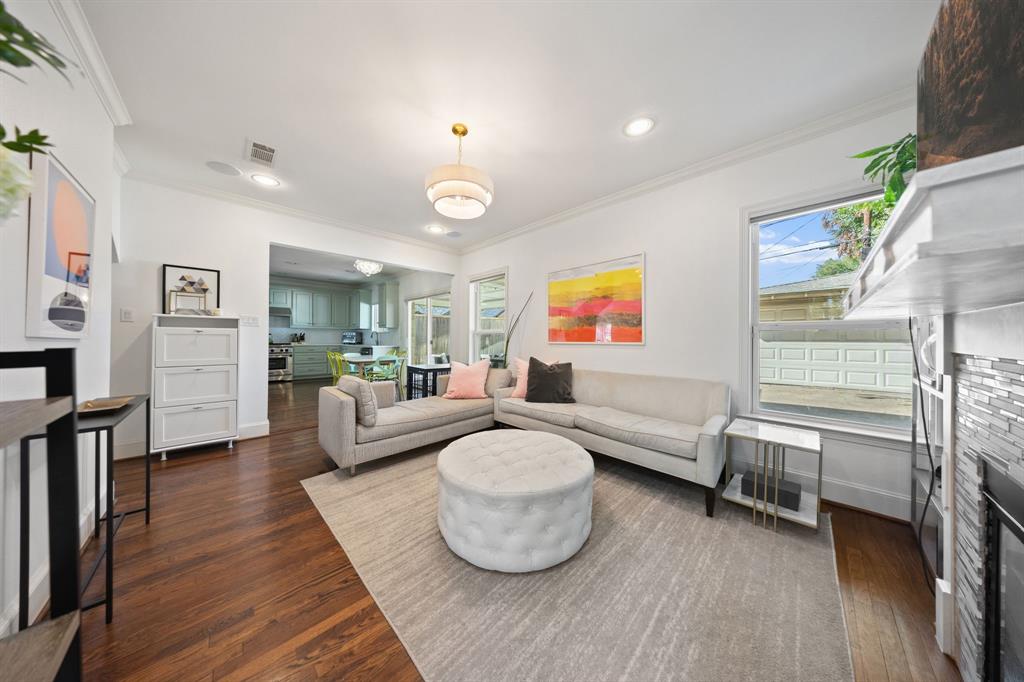Hardwood flooring throughout, recessed lighting, and crown molding