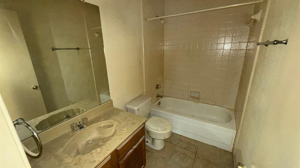 White porcelain bathtub with tiled surround