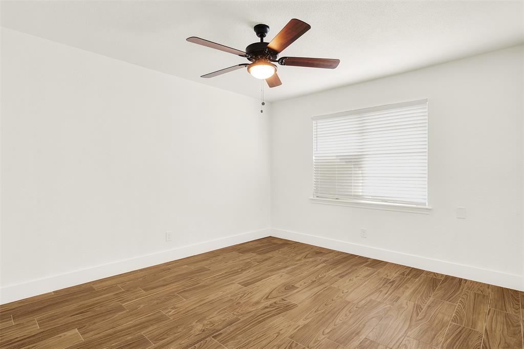 Unfurnished room with light hardwood / wood-style flooring and ceiling fan