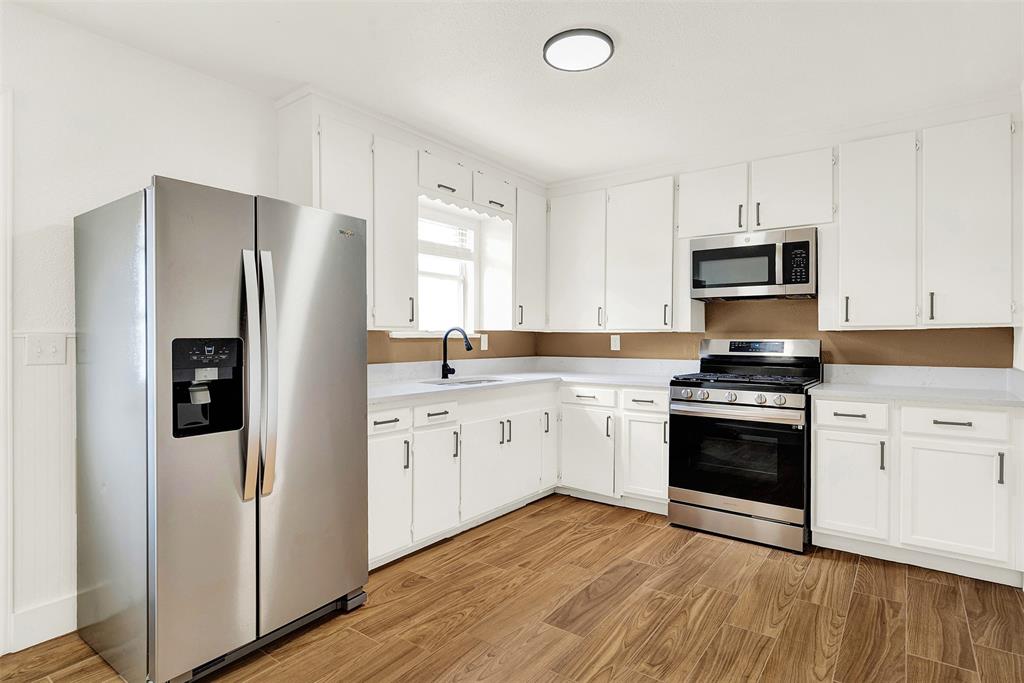 Gas Stovetop..Updated Kitchen with white cabinets, light hardwood / wood-style floors, and appliances with stainless steel finishes Gas Stovetop..Updated Kitchen with white cabinets, light hardwood / wood-style floors, and appliances with stainless steel finishes