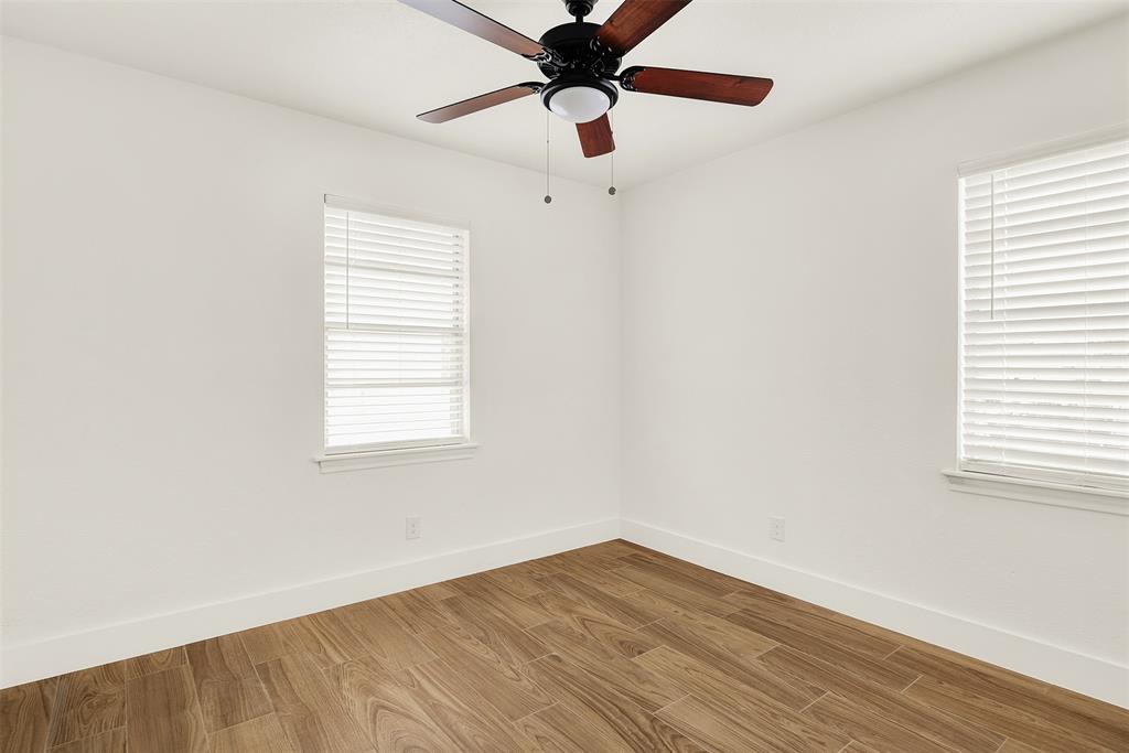 Second Bedroom with ceiling fan, light wood-type flooring, and plenty of natural light