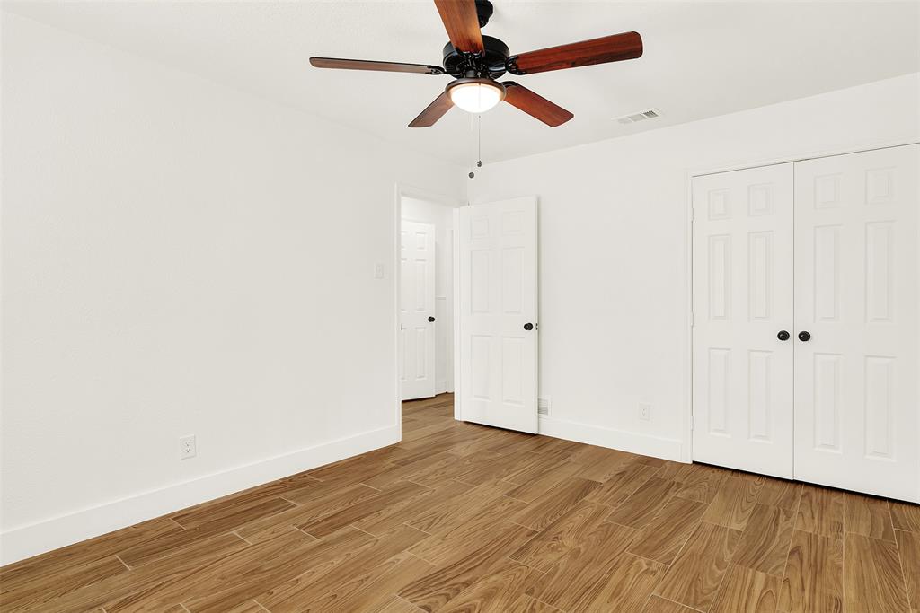 Unfurnished bedroom with ceiling fan, light hardwood / wood-style flooring, and a closet