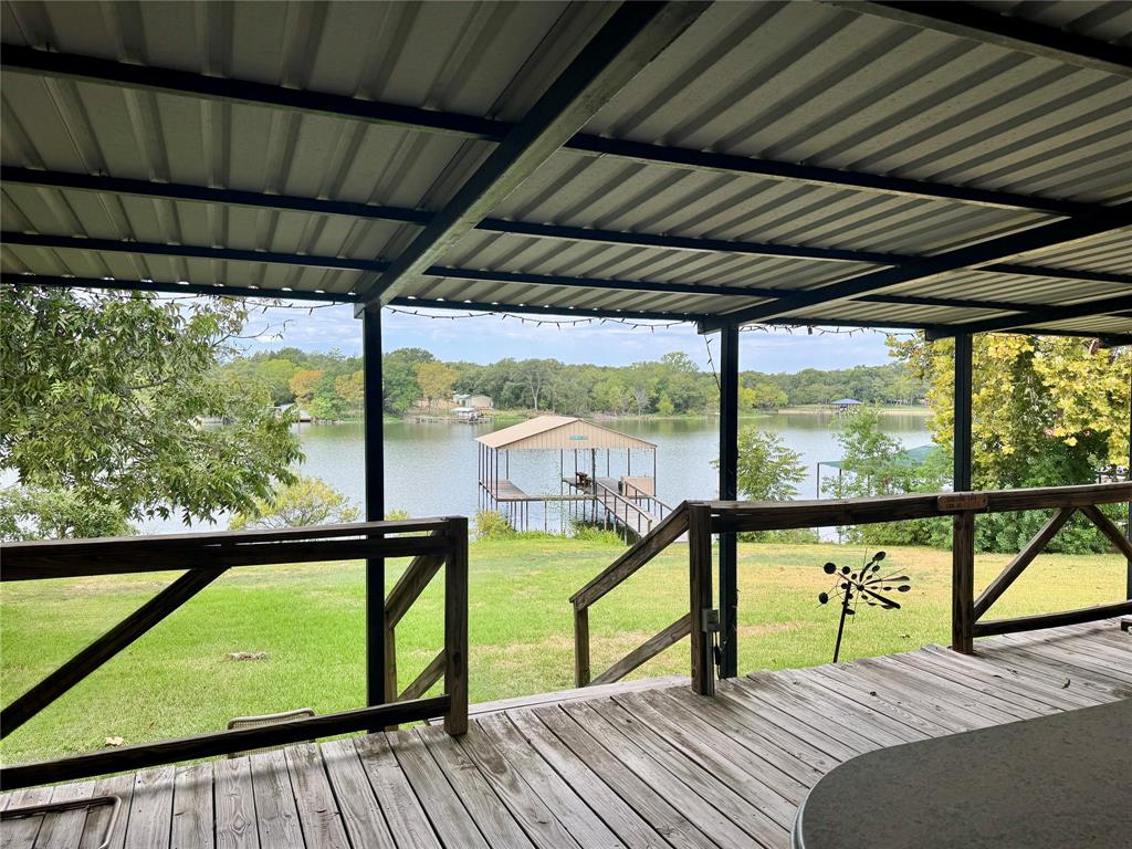 Expansive wooden deck with an overhead metal roof structure