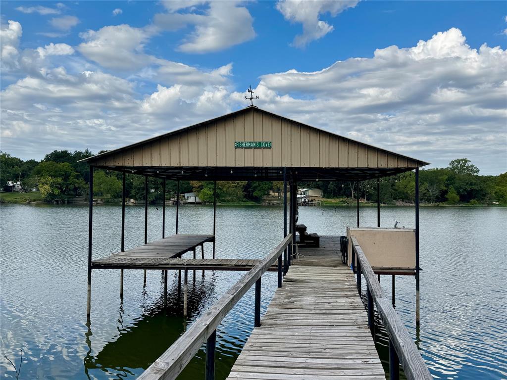 Covered boat dock with an extended wooden walkway and an additional platform