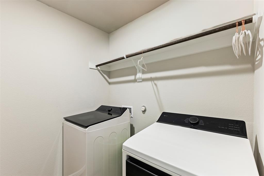 Washroom with washing machine and clothes dryer