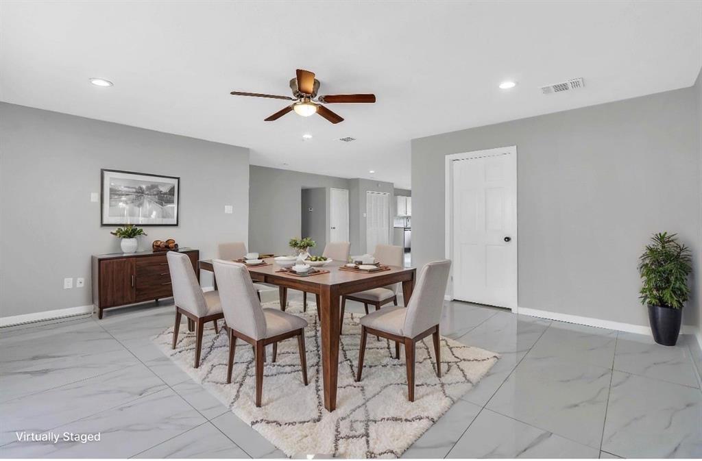 Spacious dining area featuring large format tile flooring, a contemporary ceiling fan, recessed lighting, and light grey wall tones