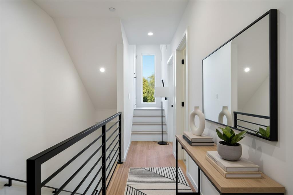 Black railing, light wood flooring, leading up to the Patio