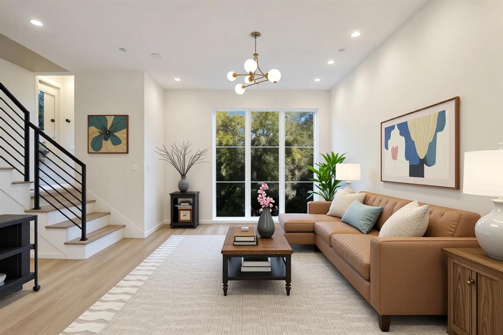 High ceilings featuring recessed lighting, a modern chandelier, and large windows
