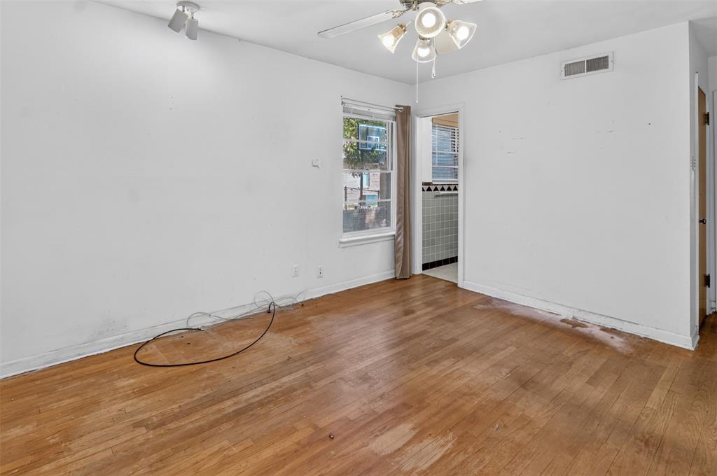 Wood-finish flooring with a ceiling fan light fixture and recessed ceiling light