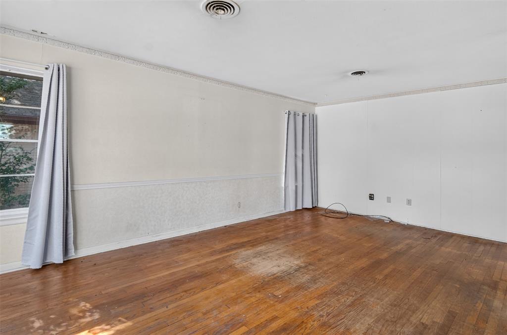 Hardwood flooring, crown molding, chair rail molding, and a window with trim