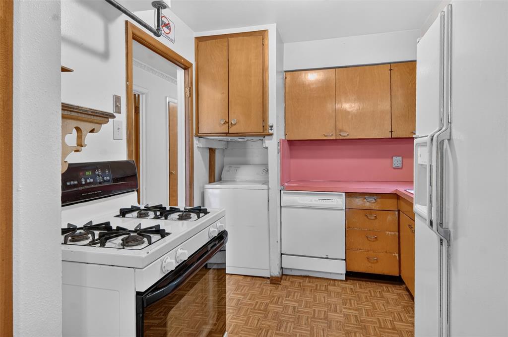 Kitchen featuring wood-finish cabinetry, white stove, white refrigerator, and wood-finish flooring