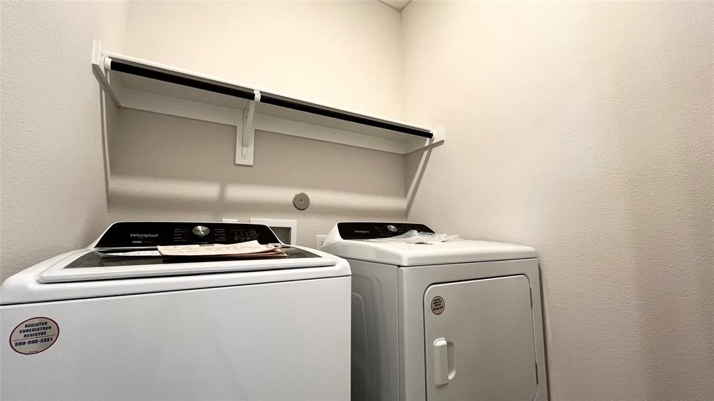 Built-in shelving with hanging rod, and a full-size washer and dryer