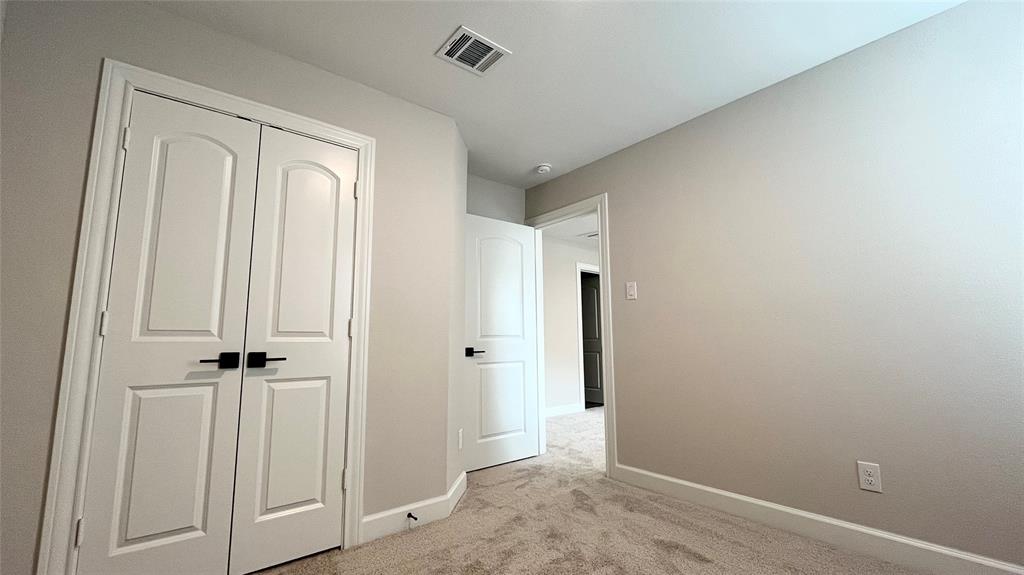 Light-colored carpeting, white baseboards, and neutral wall paint