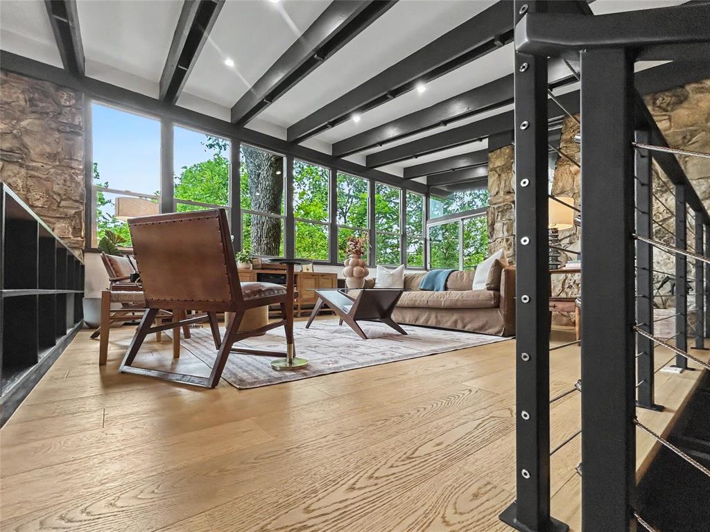 MCM stone walls with open beams, a wall of windows, and treehouse vibes throughout MCM stone walls with open beams, a wall of windows, and treehouse vibes throughout
