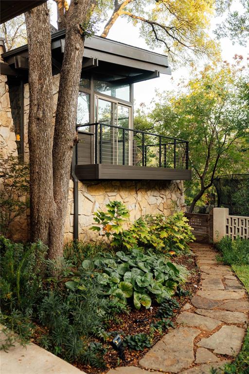 Flagstone walkway and native landscape beneath treehouse kitchen balcony