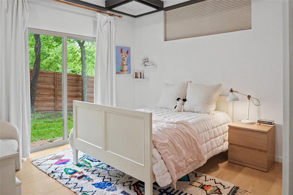 Bright guest bedroom with garden views on the entry level