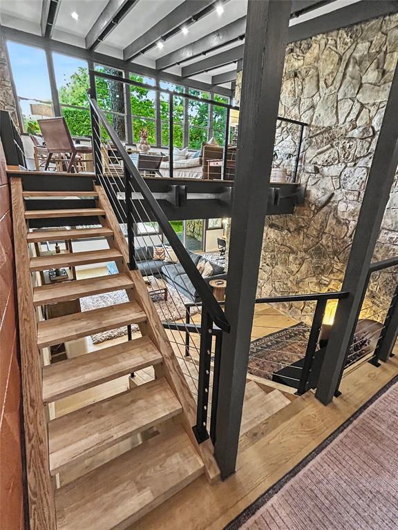 Open-tread stairs with treehouse living above and lower living below