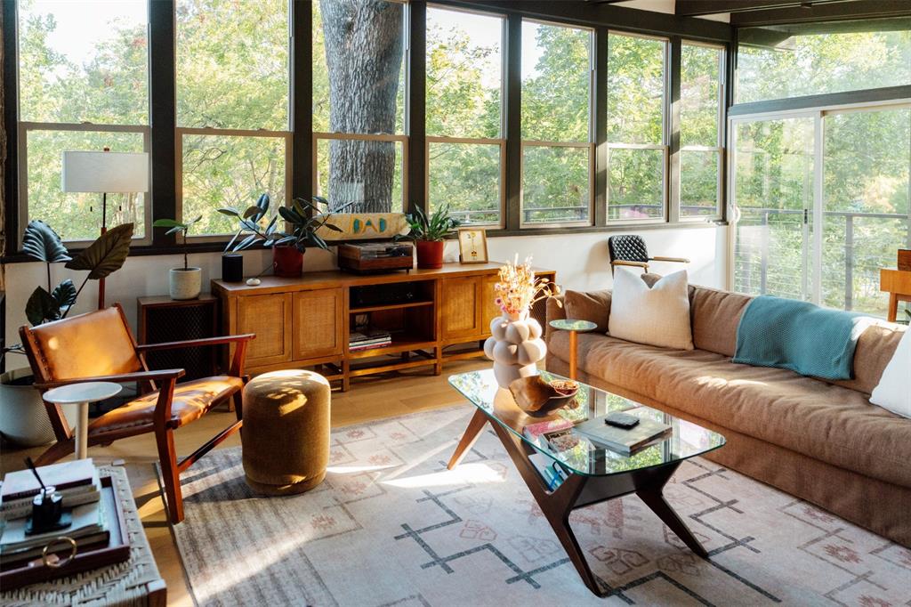 Treehouse living room on the main level, wrapped in windows and oak canopy Treehouse living room on the main level, wrapped in windows and oak canopy