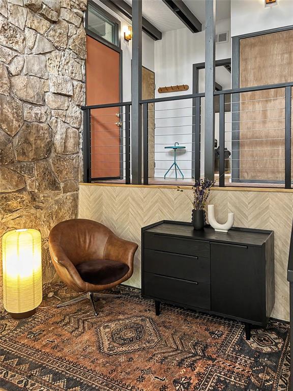 Reading nook with a herringbone wall and a peek up to the entry level