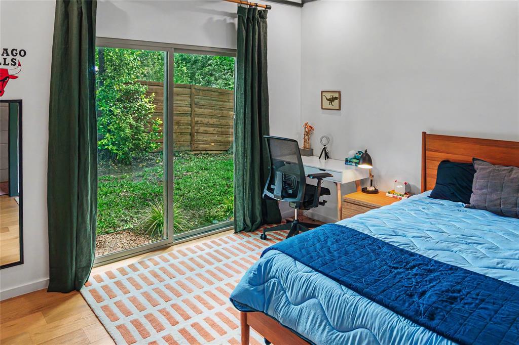 Bright guest bedroom with garden views on the entry level