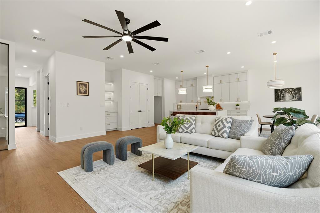 Open concept living space with recessed lighting, wood-finish flooring, and a modern ceiling fan
