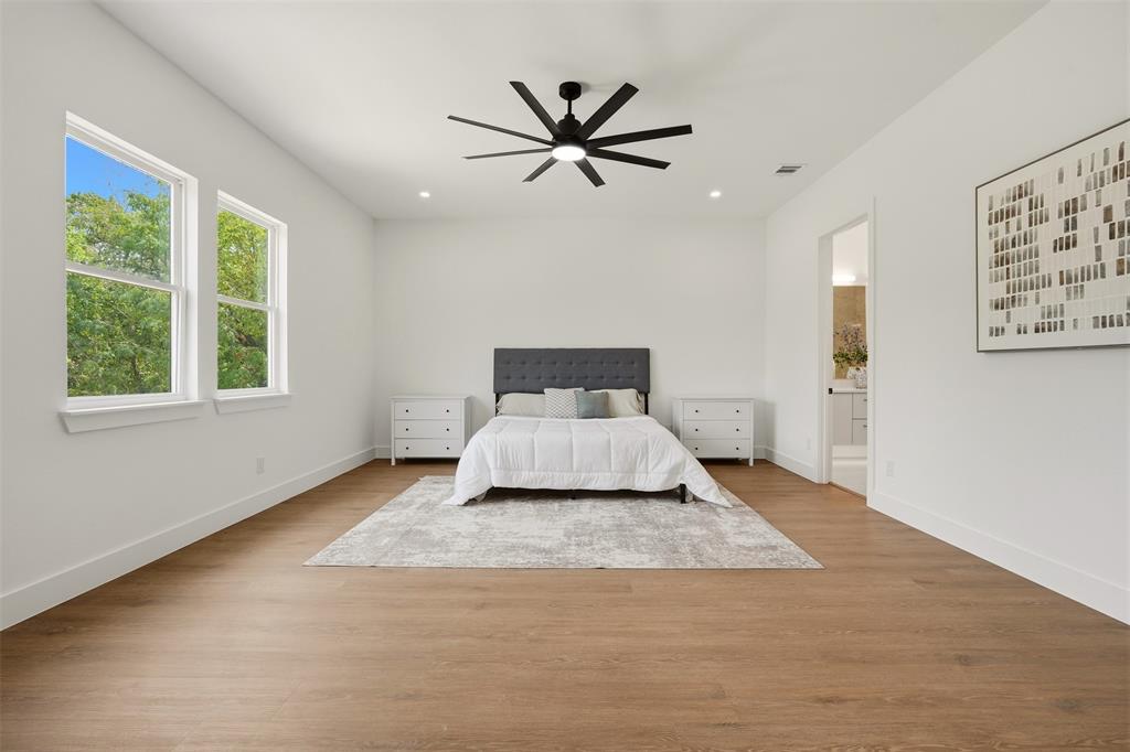 Spacious room featuring wood-finish flooring, recessed lighting, and a modern ceiling fan